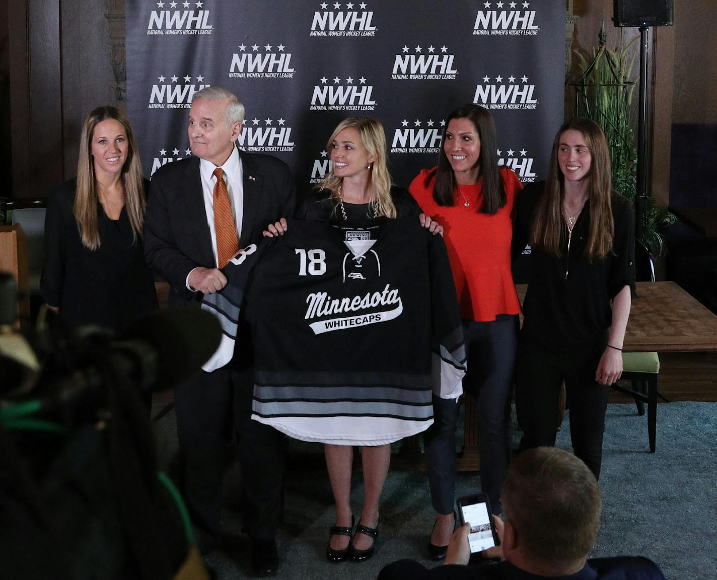 Gov. Mark Dayton posed for a photo with, from left, Whitecaps captain Winny Brodt Brown, league founder and commissioner Dani Rylan, and deputy commissioner Hayley Moore following the announcement. ] ANTHONY SOUFFLE ï anthony.souffle@startribune.com Officials with the National Women's Hockey League held a press conference to announce they had acquired the Minnesota Whitecaps Tuesday, May 15, 2018 at Herbie's on the Park in St. Paul, Minn.