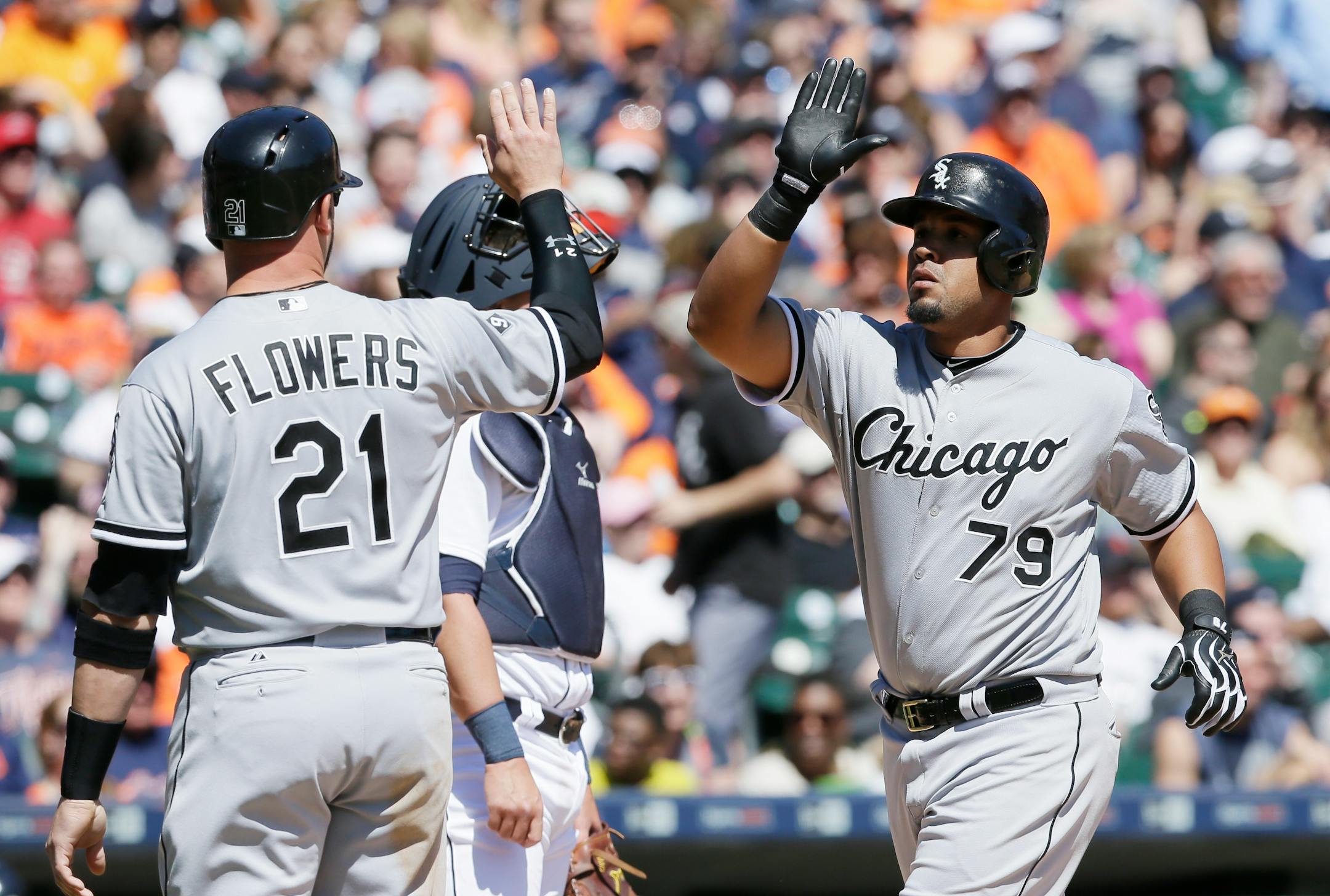 Chicago White Sox's Jose Abreu (79) greets Tyler Flowers after Abreu's grand slam during the fourth inning of a baseball game against the Detroit Tigers, Saturday, April 18, 2015, in Detroit. (AP Photo/Carlos Osorio)