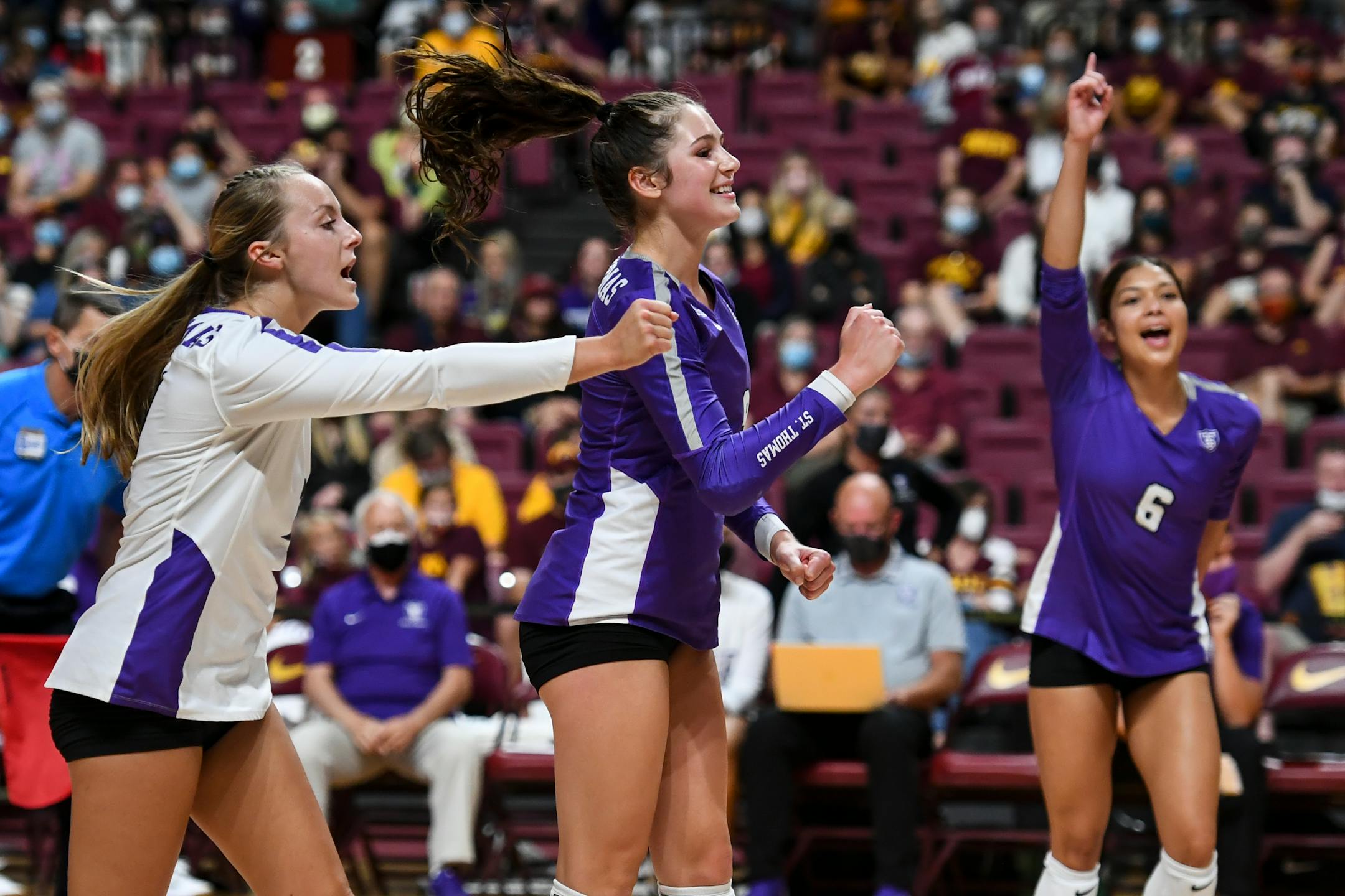 From left, St. Thomas outside hitter Carrie Rutledge (7), outside hitter Lauren Galvin (9) and outside hitter Fran Egan (6) celebrated a third set point against the University of Minnesota Gophers.