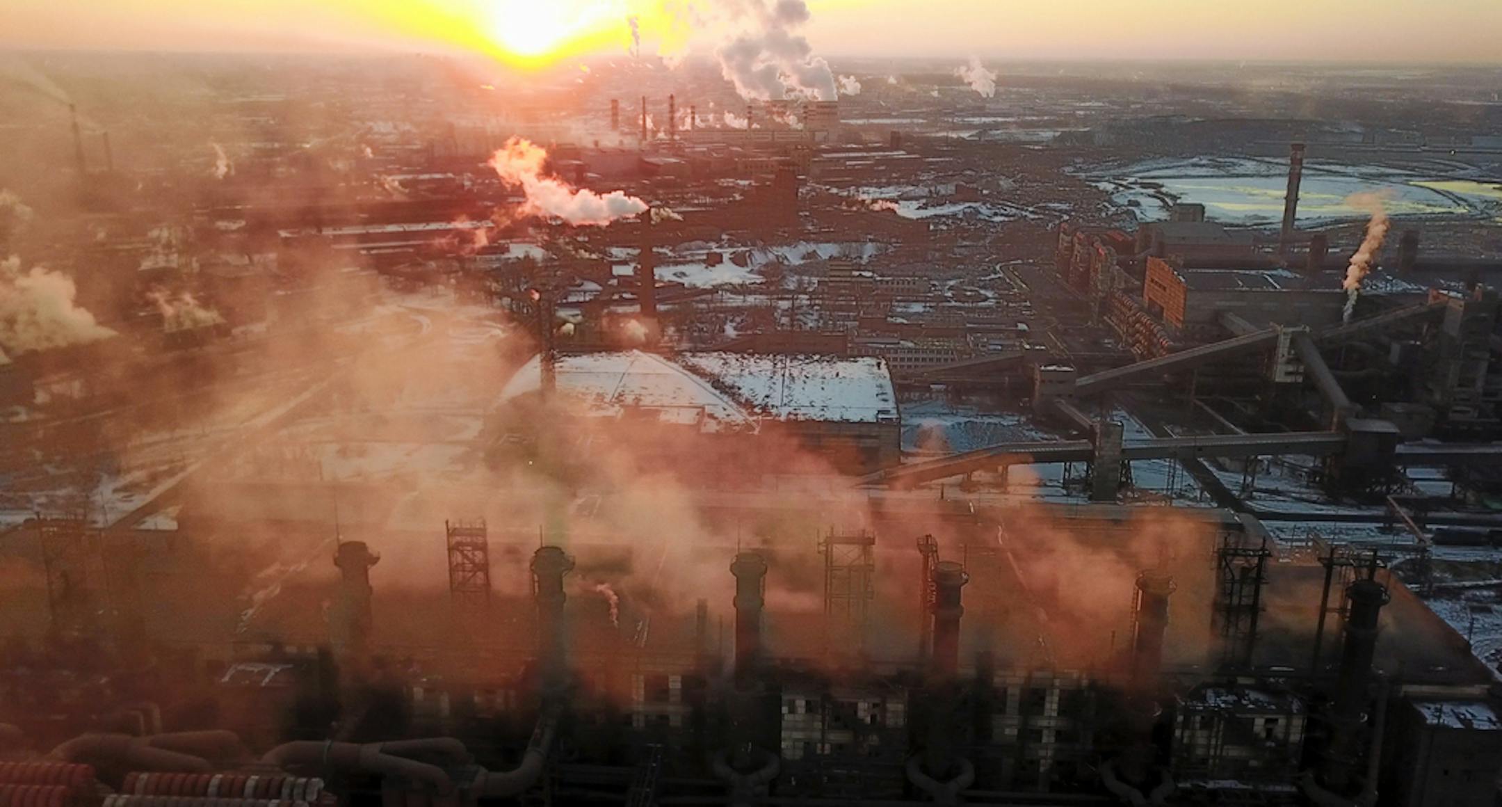 In this March 21, 2018 photo smog and fog rise from the Chelyabinsk Electrometallurgical Plant in Chelyabinsk, Russia. Residents of Chelyabinsk are expressing worry over industrial pollution after heavy smog enveloped the Ural Mountains city this month and remained for two weeks. On Sunday, Dec. 23, 2018 about 700 protesters braved temperatures of -20 degrees Celsius (-4 degrees Fahrenheit) to demand cleaner air. (AP Photo/Dmitry Balakiev)