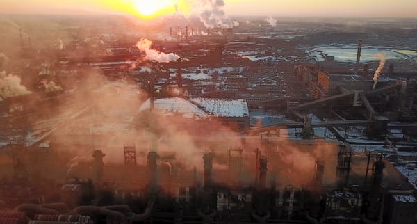 In this March 21, 2018 photo smog and fog rise from the Chelyabinsk Electrometallurgical Plant in Chelyabinsk, Russia. Residents of Chelyabinsk are ex