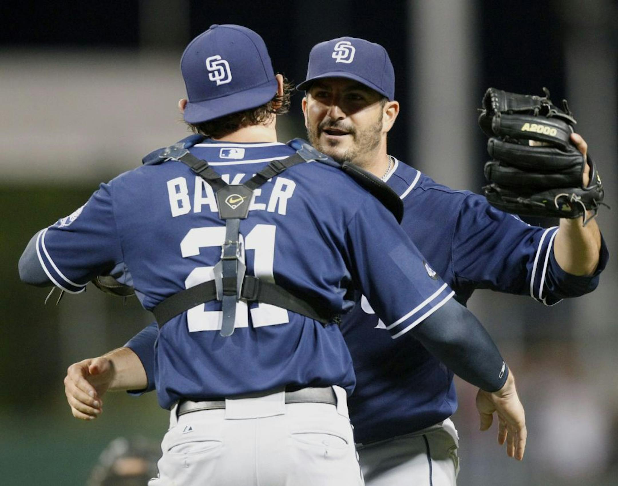 San Diego Padres starting pitcher Jason Marquis, right, is congratulated by catcher John Baker after getting the last out in the ninth inning of the baseball game against the Pittsburgh Pirates, Saturday, Aug. 11, 2012, in Pittsburgh. Marquis pitched a complete game shutout, giving up only two hits in the Padres' 5-0 win.