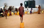 Outside the Dadaab refugee camp in eastern Kenya, a Somali boy waited to collect water. Kenya has threatened to close the camp, the world&#x2019;s lar