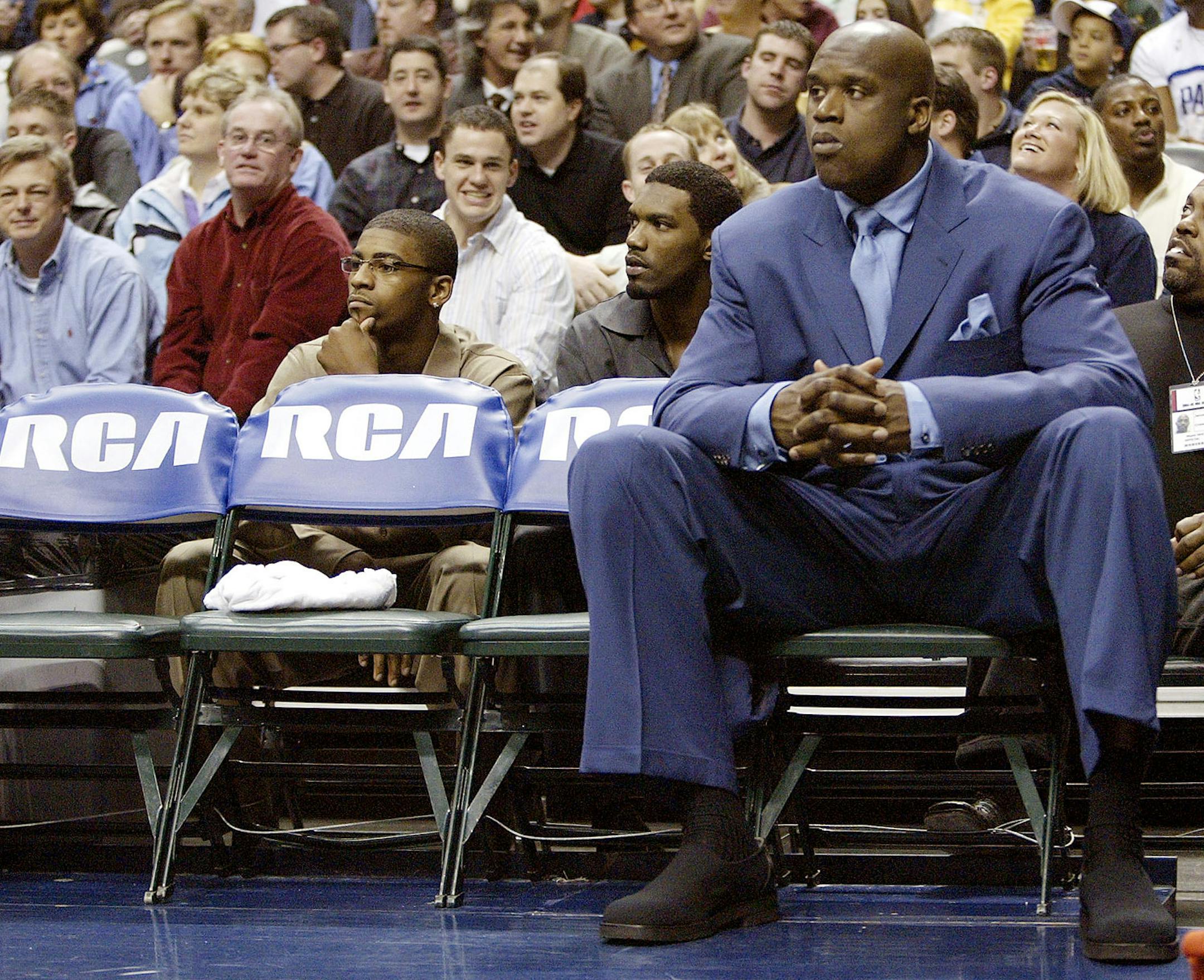 ** FILE ** Miami Heat's Shaquille O'Neal sits on the bench during a time out as the Heat played the Indiana Pacers in the first quarter in Indianapolis. in this Feb. 23, 2005 file photo. On Monday, Oct. 17, 2005 the NBA announced in a memo to teams that a dress code will go into effect at the start of the season which requires players on the bench who are not in uniform to wear sports jackets, shoes and socks. (AP Photo/Michael Conroy)