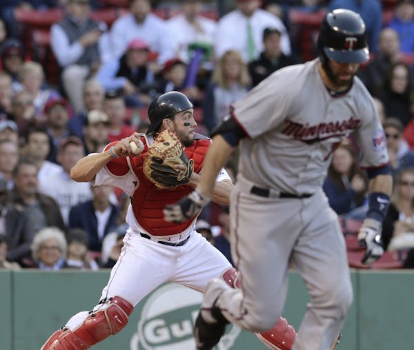 Boston Red Sox catcher Blake Swihart, left, throws to third baseman Pablo Sandoval after a bunt by Minnesota Twins' Joe Mauer during the ninth inning 