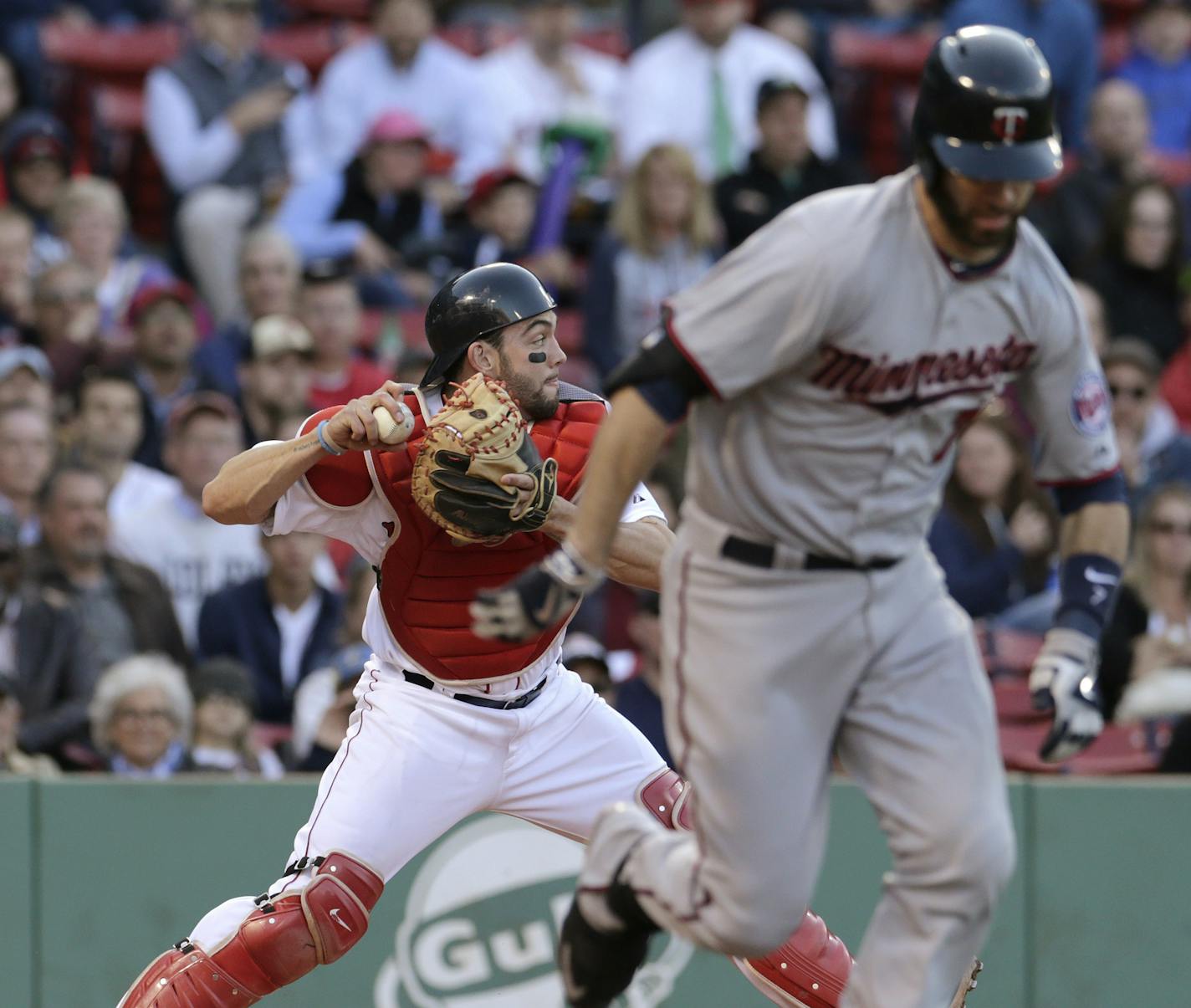 Boston Red Sox catcher Blake Swihart, left, throws to third baseman Pablo Sandoval after a bunt by Minnesota Twins' Joe Mauer during the ninth inning of a baseball game at Fenway Park on Thursday, June 4, 2015, in Boston. Sandoval mishandled the catch, allowing Brian Dozier to score on the play. The Twins defeated the Red Sox 8-4. (AP Photo/Charles Krupa)