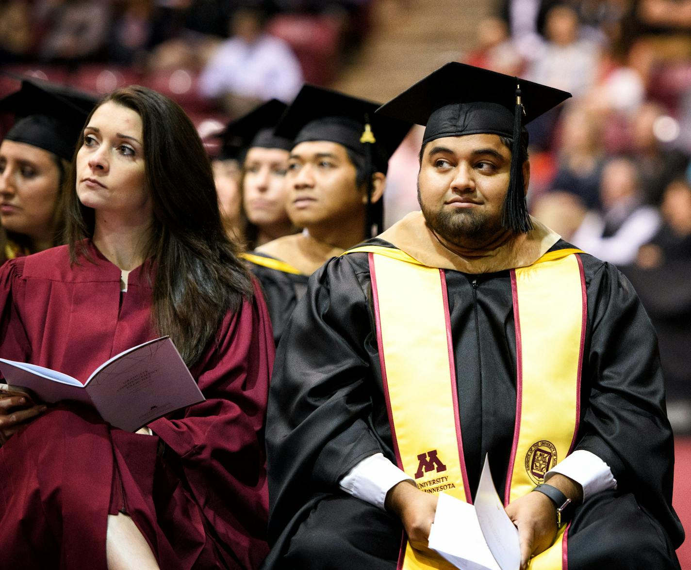 Murid Amini held a copy of his speech in his hand, waiting to be called by Dean Sri Zaheer. ] GLEN STUBBE * gstubbe@startribune.com Monday, May 16, 2016 Murid Amini will earn his first generation, Afghani immigrant family's 3rd U of M masters degree, marking a total of 43 years of enrollment, 9 undergrad degrees and one Ph.D. among the 8 Amini brothers at the Carlson School's part-time MBA graduation ceremony Monday.