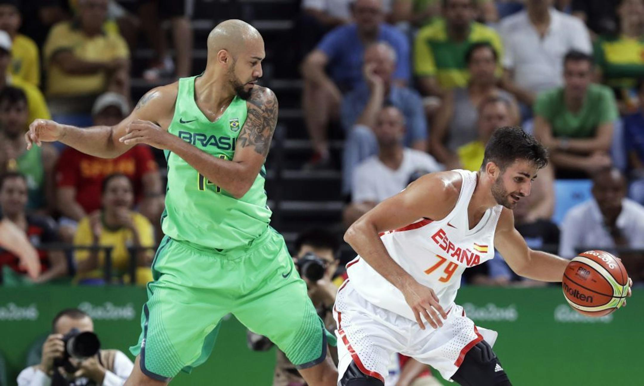 Spain's Ricky Rubio (79) grabs a loose ball in front of Brazil's Marcus Marquinhos, left, during a basketball game at the 2016 Summer Olympics in Rio de Janeiro, Brazil, Tuesday, Aug. 9, 2016.