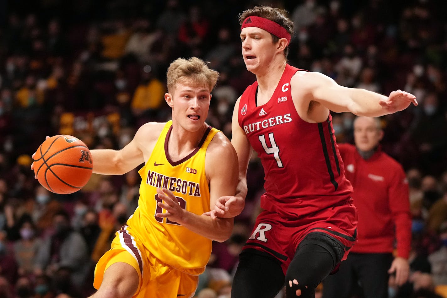 Gophers guard Luke Loewe took the ball around Rutgers guard Paul Mulcahy in the first half Saturday.