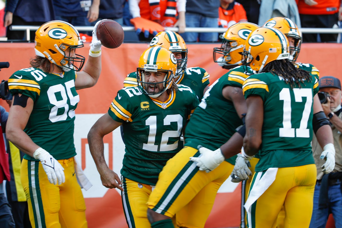 Green Bay Packers quarterback Aaron Rodgers (12) celebrates with teammates after scoring a touchdown during the second half of an NFL football game against the Chicago Bears, Sunday, Oct. 17, 2021, in Chicago. (AP Photo/Kamil Krzaczynski)