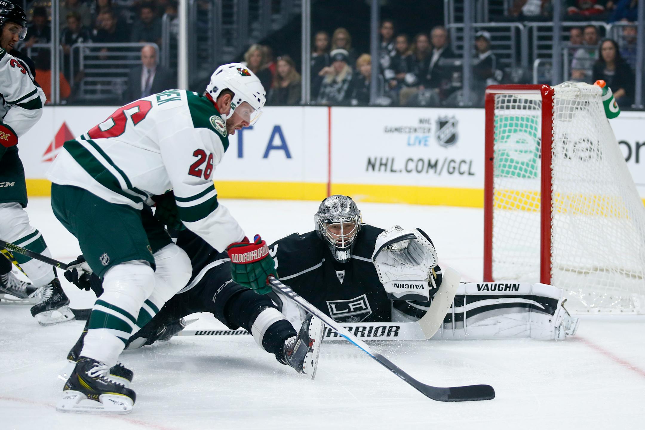 Minnesota Wild left wing Thomas Vanek, left, controls the puck in front of Los Angeles Kings goalie Jonathan Quick, right, during the first period of an NHL hockey game, Friday, Oct. 16, 2015, in Los Angeles. (AP Photo/Danny Moloshok)