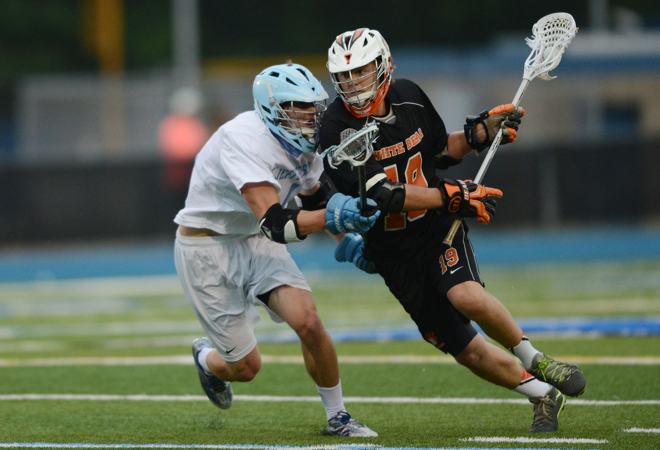 Bloomington Jefferson's Nate Buswell attempted to stop White Bear Lake Area's Connor Dehnert in the 1st quarter Saturday evening in Minnetonka. ] RACHEL WOOLF ï rachel.woolf@startribune.com White Bear Lake Area met Bloomington Jefferson in a boys state lacrosse tournament championship game at Minnetonka High School in Minnetonka Saturday evening, June 13, 2015.