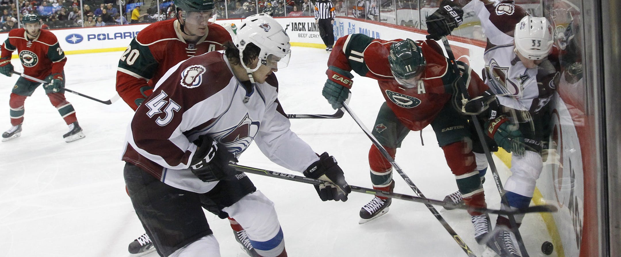 Colorado Avalanche left wing Cody McLeod (55), Minnesota Wild left wing Zach Parise (11) and Avalanche right wing Dennis Everberg (45) battle for the puck during the second period of an NHL hockey game in St. Paul, Minn., Saturday, Feb. 7, 2015. (AP Photo/Ann Heisenfelt)