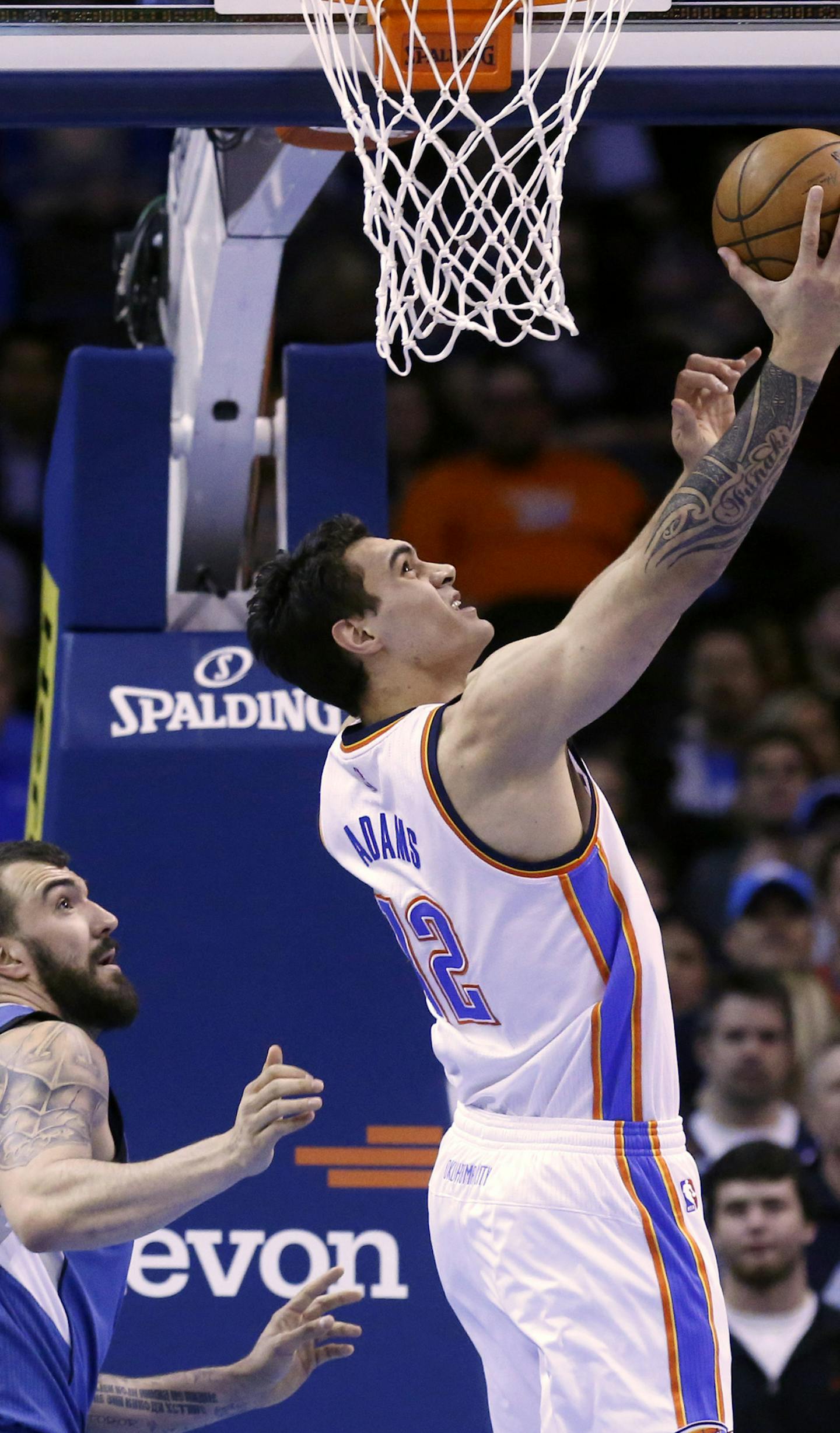 Oklahoma City Thunder center Steven Adams (12) shoots in front of Minnesota Timberwolves center Nikola Pekovic, left, in the first quarter of an NBA basketball game in Oklahoma City, Monday, Jan. 26, 2015. (AP Photo/Sue Ogrocki)