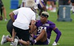 Vikings receiver Bisi Johnson was helped by trainers in practice Friday.