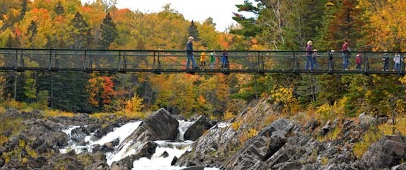 Kindergarten students from Amy Labernik's Winterquist Elementary School class of Esko, Minn., walked across the swing bridge at Jay Cooke State Park not far from Duluth on Tuesday. Autumn tree colors are peaking in the region.