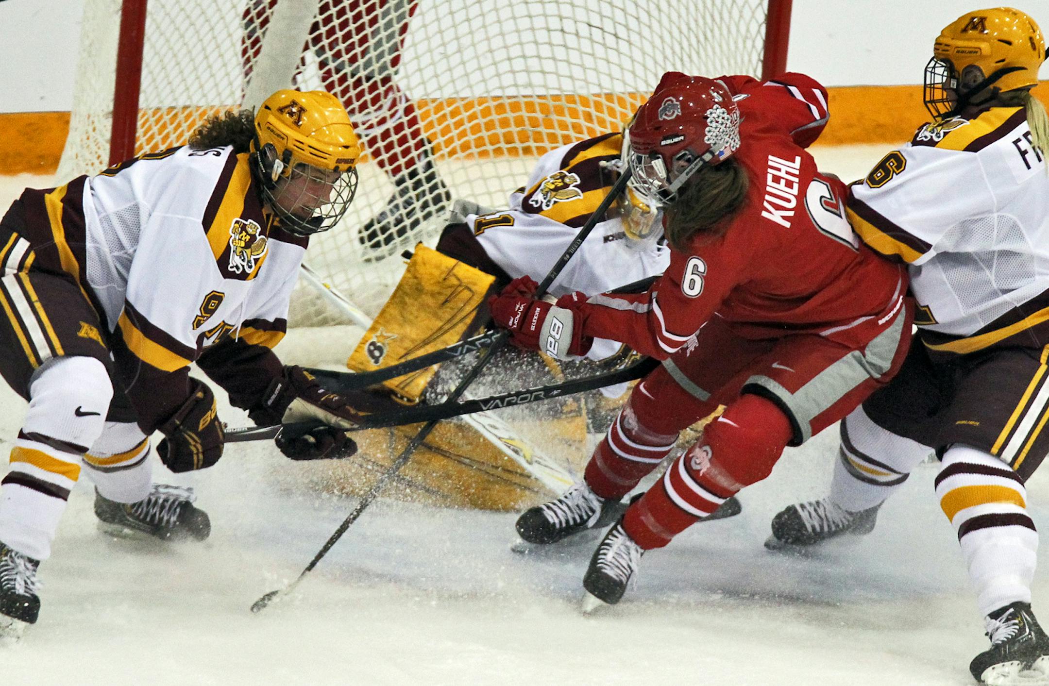 WCHA WOMEN'S HOCKEY PLAYOFFS - Minnesota vs. Ohio State. Minnesota put the defensive squeeze on Ohio State's Taylor Kuehl as she attempted a shot-on-goal. (MARLIN LEVISON/STARTRIBUNE(mlevison@startribune.com (cq -PROGRAM)