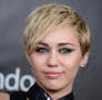 FILE - In this Oct. 29, 2014 file photo, Miley Cyrus arrives at the 2014 amfAR Inspiration Gala at Milk Studios in Los Angeles. A convicted burglar ch