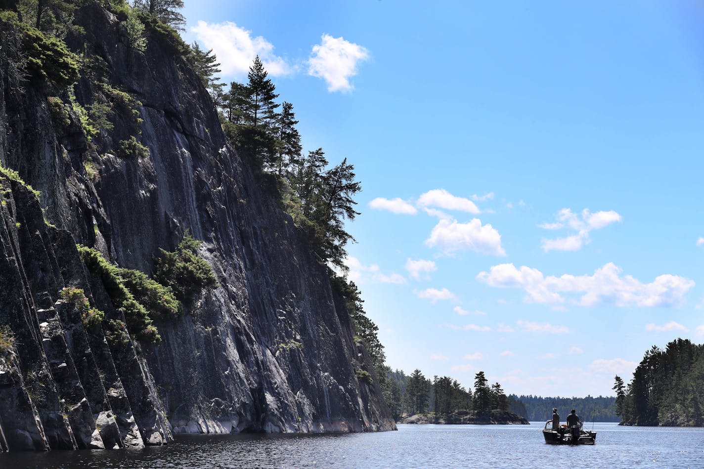 Fishermen float near the Grassy Bay Cliffs in Sand Point Lake in Voyageurs National Park.