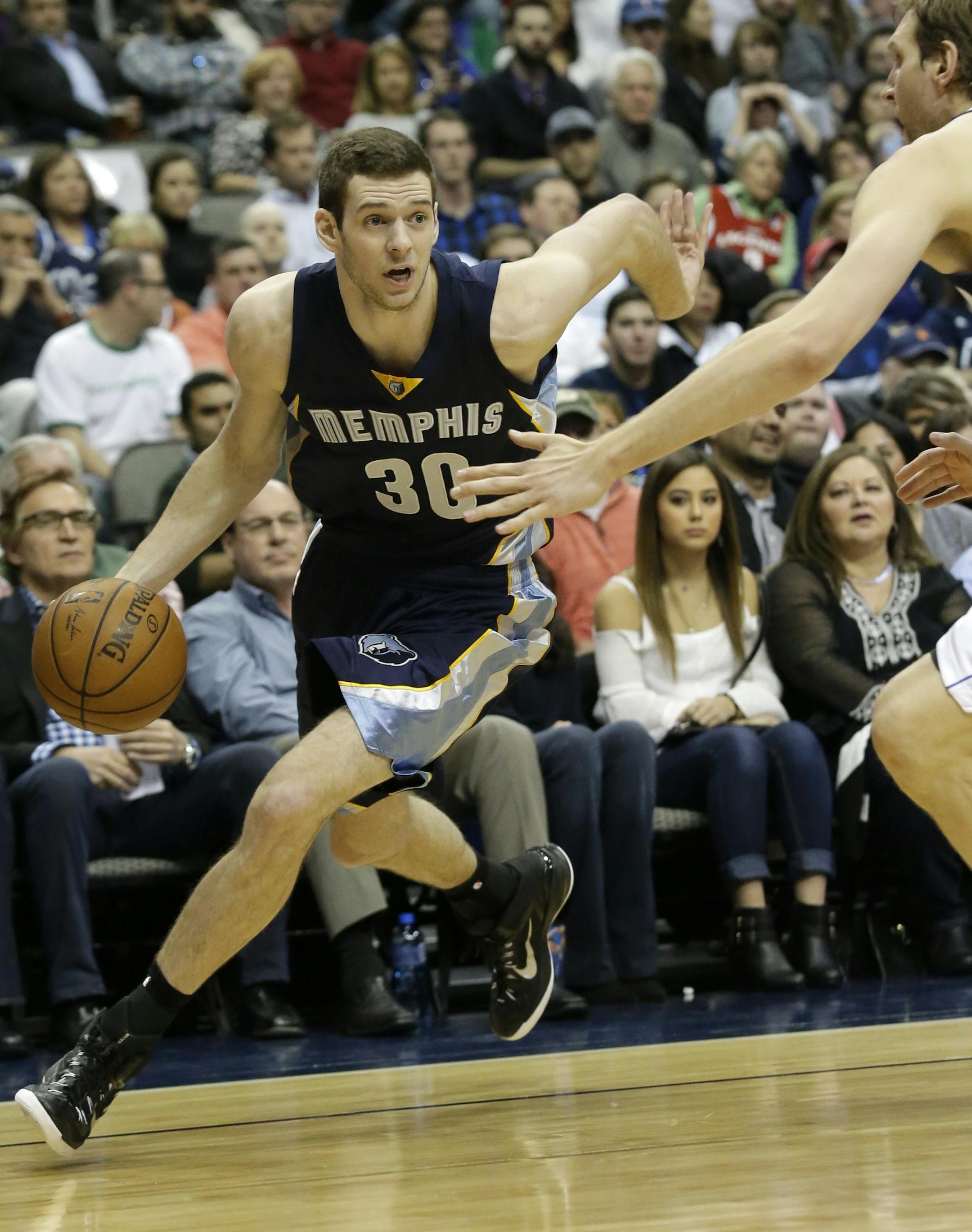 Memphis Grizzlies forward Jon Leuer (30) drives against Dallas Mavericks forward Dirk Nowitzki during the first half of an NBA basketball game Tuesday, Jan. 27, 2015, in Dallas. (AP Photo/LM Otero) ORG XMIT: DNA101