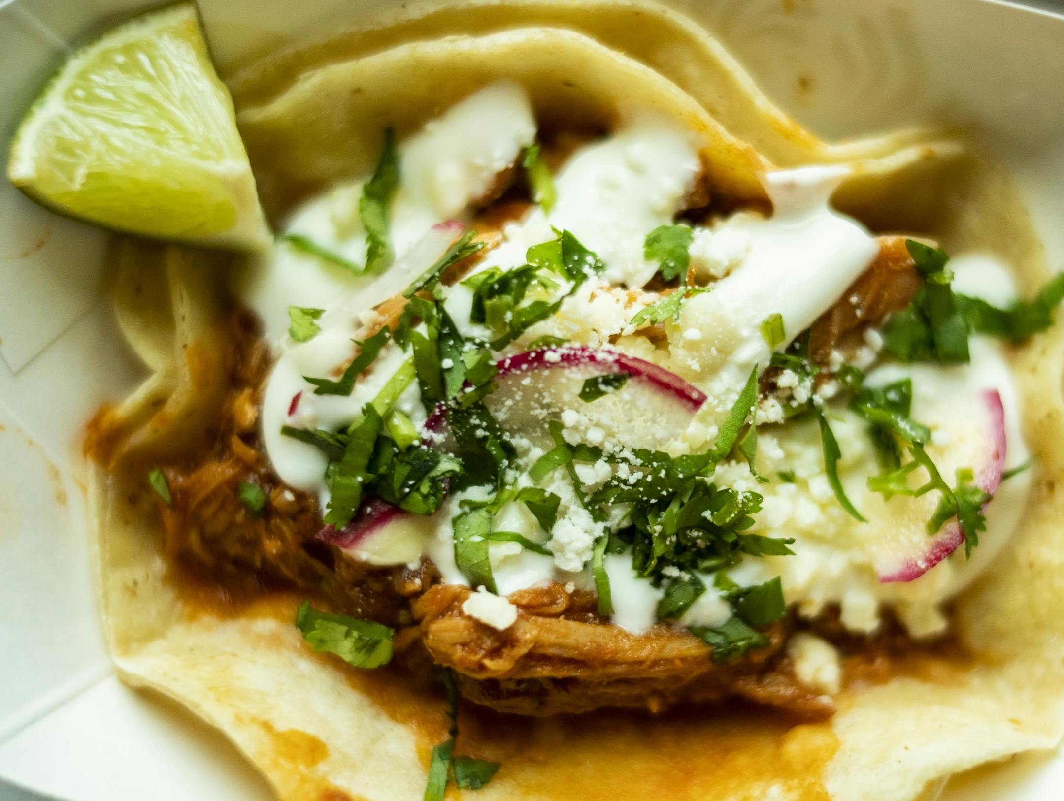 The Tinga which has chipotle-tomato chicken, beans, crema and queso.