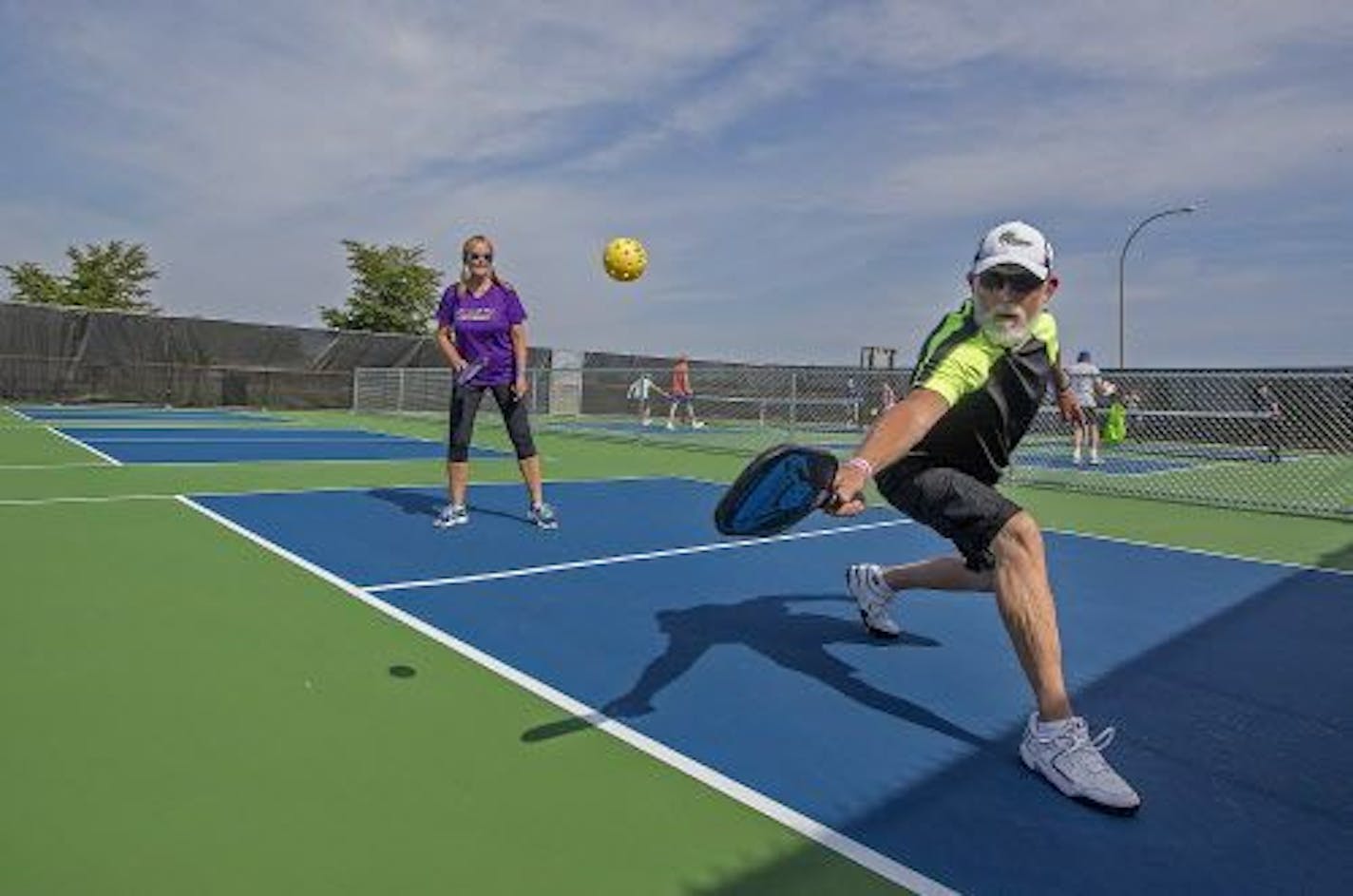 Bob Minter and Anna Hobbs paired up for a game pickle ball at the new pickle ball courts, Tuesday, July 11, 2017 at Forest Lake's Fenway Park in Forest Lake, MN. The courts have only been open a few weeks, but they're already proving popular with a hundred or so regulars drawn to the exercise -- and socializing.