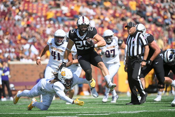 Gophers running back Preston Jelen rushes for a touchdown as he breaks a tackle by Western Illinois defensive back Corey Scott (24) in the second half
