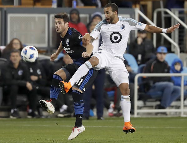 San Jose Earthquakes midfielder Vako (11) battles for the ball against Minnesota United defender Tyrone Mears (4) during the first half of an MLS socc