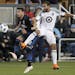 San Jose Earthquakes midfielder Vako (11) battles for the ball against Minnesota United defender Tyrone Mears (4) during the first half of an MLS socc