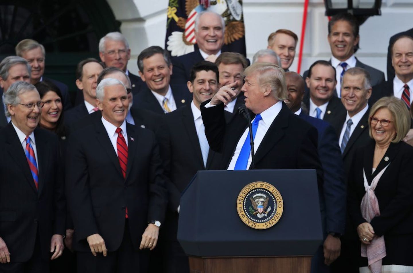 Republican lawmakers including, from left, Senate Majority Leader Mitch McConnell, Vice President Mike Pence and House Speaker Paul Ryan reacted as President Donald Trump spoke about the tax overhaul at the White House on Wednesday.