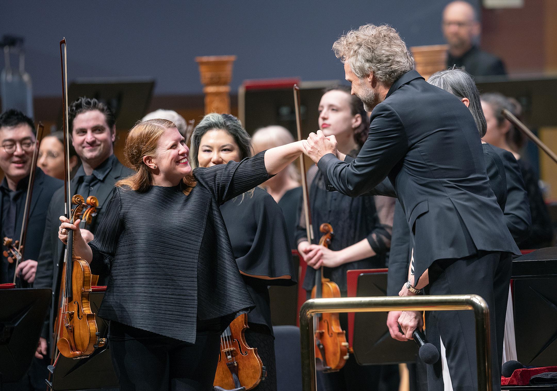Erin Keefe, the Orchestra's Concertmaster, is greeted by Thomas Søndergård as he takes the stage in his first concert as music director of the Minnesota Orchestra in Minneapolis.