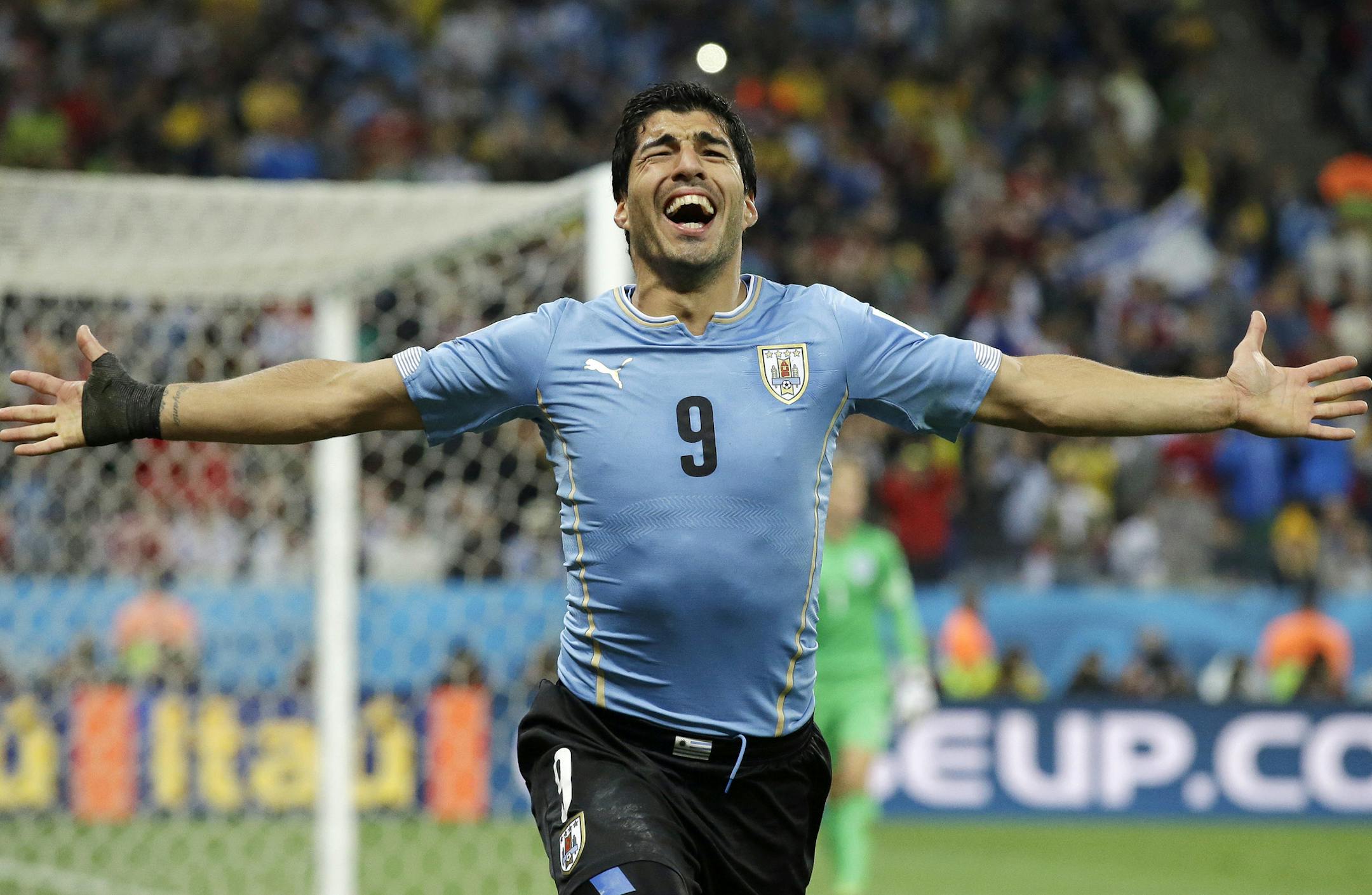 Uruguay's Luis Suarez celebrates after scoring his side's second goal during the group D World Cup soccer match between Uruguay and England at the Itaquerao Stadium in Sao Paulo, Brazil, Thursday, June 19, 2014. (AP Photo/Matt Dunham)