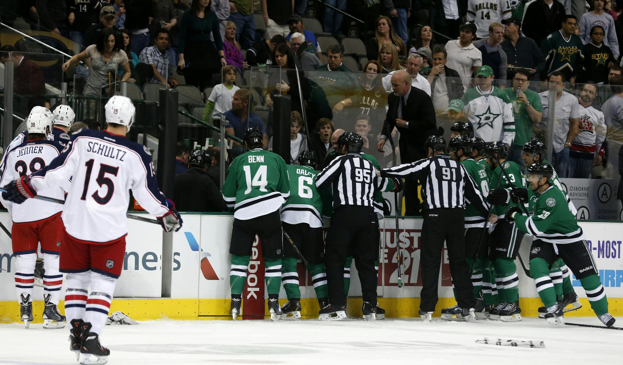 Columbus Blue Jackets and Dallas Stars players rush to the bench in the first period of an NHL Hockey game Monday, March 10, 2014, in Dallas. Stars center Rich Peverly was transported to the hospital after play was suspended. (AP Photo/Sharon Ellman) ORG XMIT: DNA105