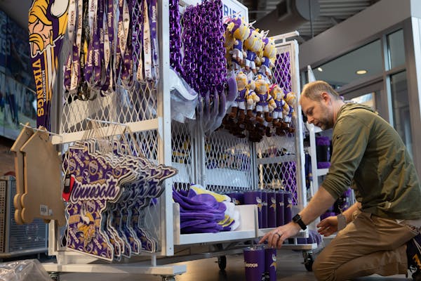 Dan Burhans stocked the Vikings team store inside U.S. Bank Stadium on Friday with more merchandise.
