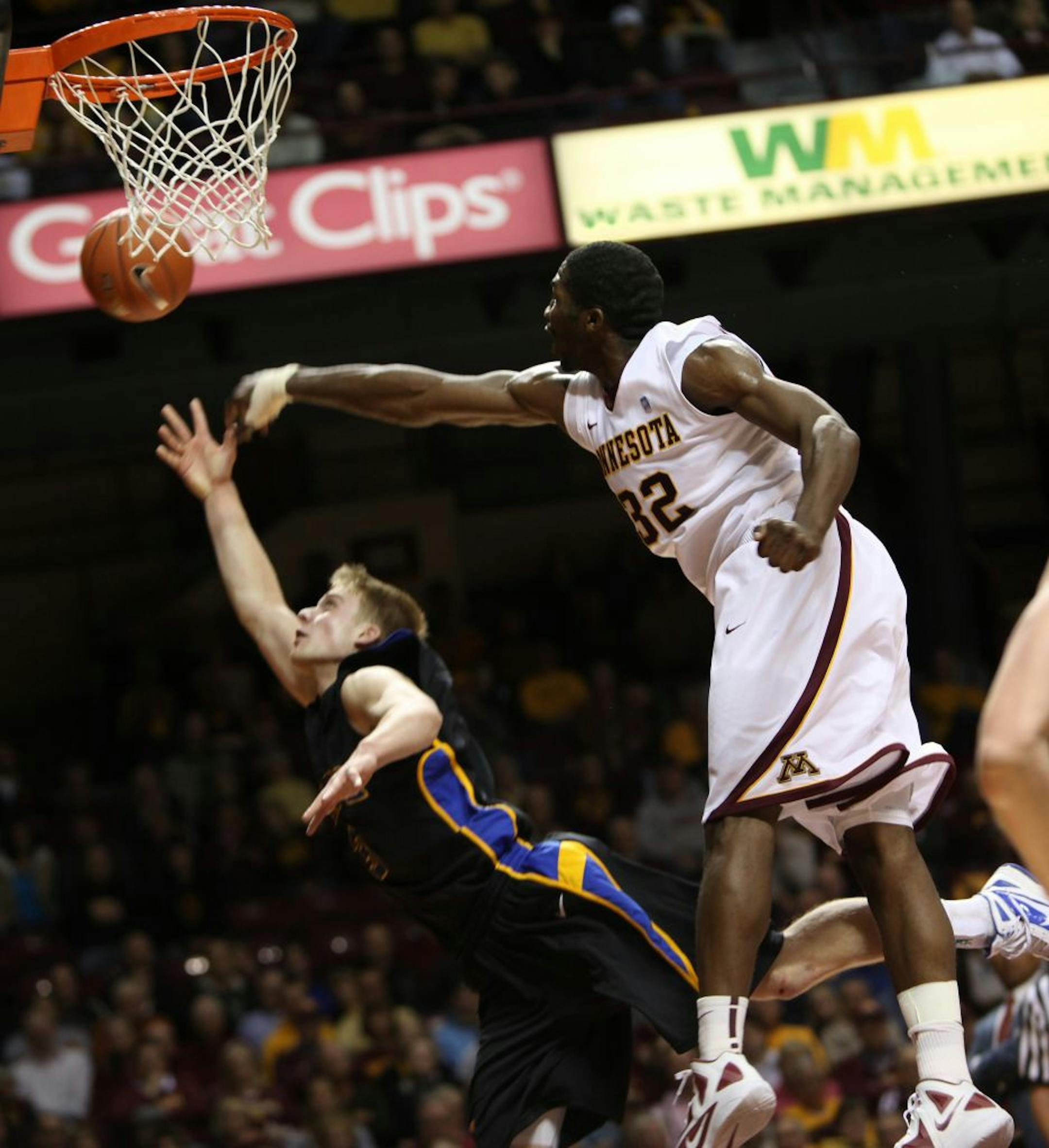 Minnesota's Trevor Mbakwe knocked the ball away from South Dakota's Nate Wolters as he attempted a shot in the first half of a men's college basketball game Monday, November 14, 2011 in Minneapolis, Minnesota.