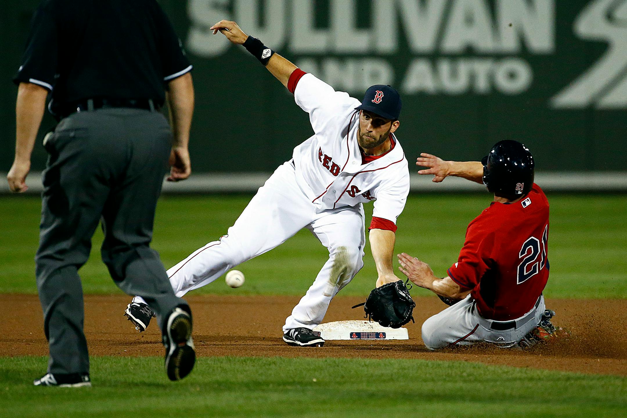 Boston Red Sox shortstop Jeff Bianchi (16) tags out Minnesota Twins right fielder Shane Robinson (21) who is caught stealing second base in seventh inning Friday, April 3, 2015 in Fort Myers, Fla. The Boston Red Sox faced the Minnesota Twins during Grapefruit League baseball action. The Twins beat the Red Sox 5-2. (AP Photo/Naples Daily News, Corey Perrine)