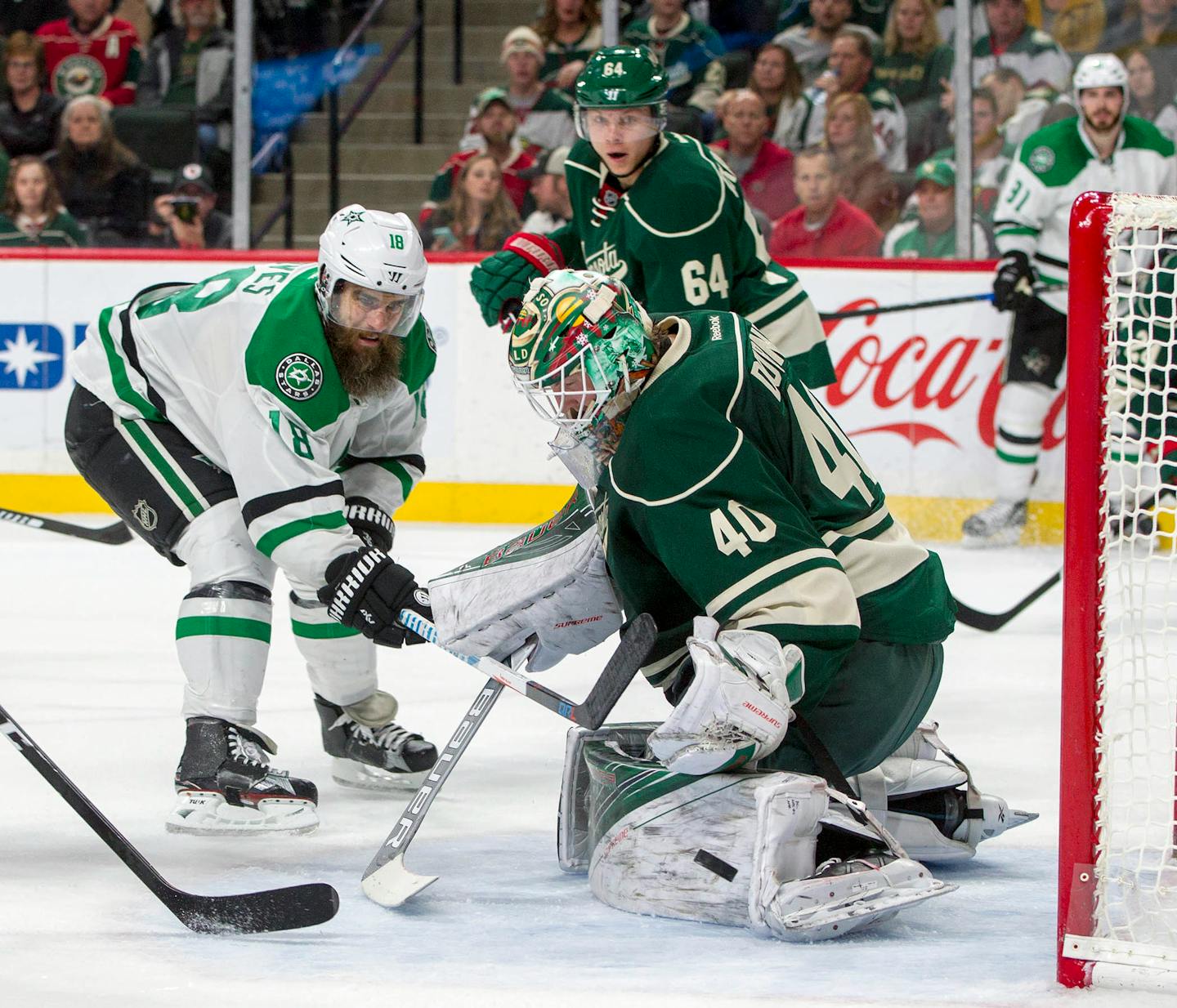 Minnesota Wild goalie Devan Dubnyk (40) stops a point blank shot by Dallas Stars right wing Patrick Eaves (18) during the second period of an NHL game, Saturday, Oct. 29, 2016, in St. Paul, Minn. Minnesota Wild center Mikael Granlund, of Finland (64) looks on during the play. (AP Photo/Paul Battaglia)