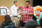 Gary Red Owl, right, a decedent of Santee Chief Cut Nose, receives an apology letter from Jeff Bolton, the Vice President and Chief Administrative Off
