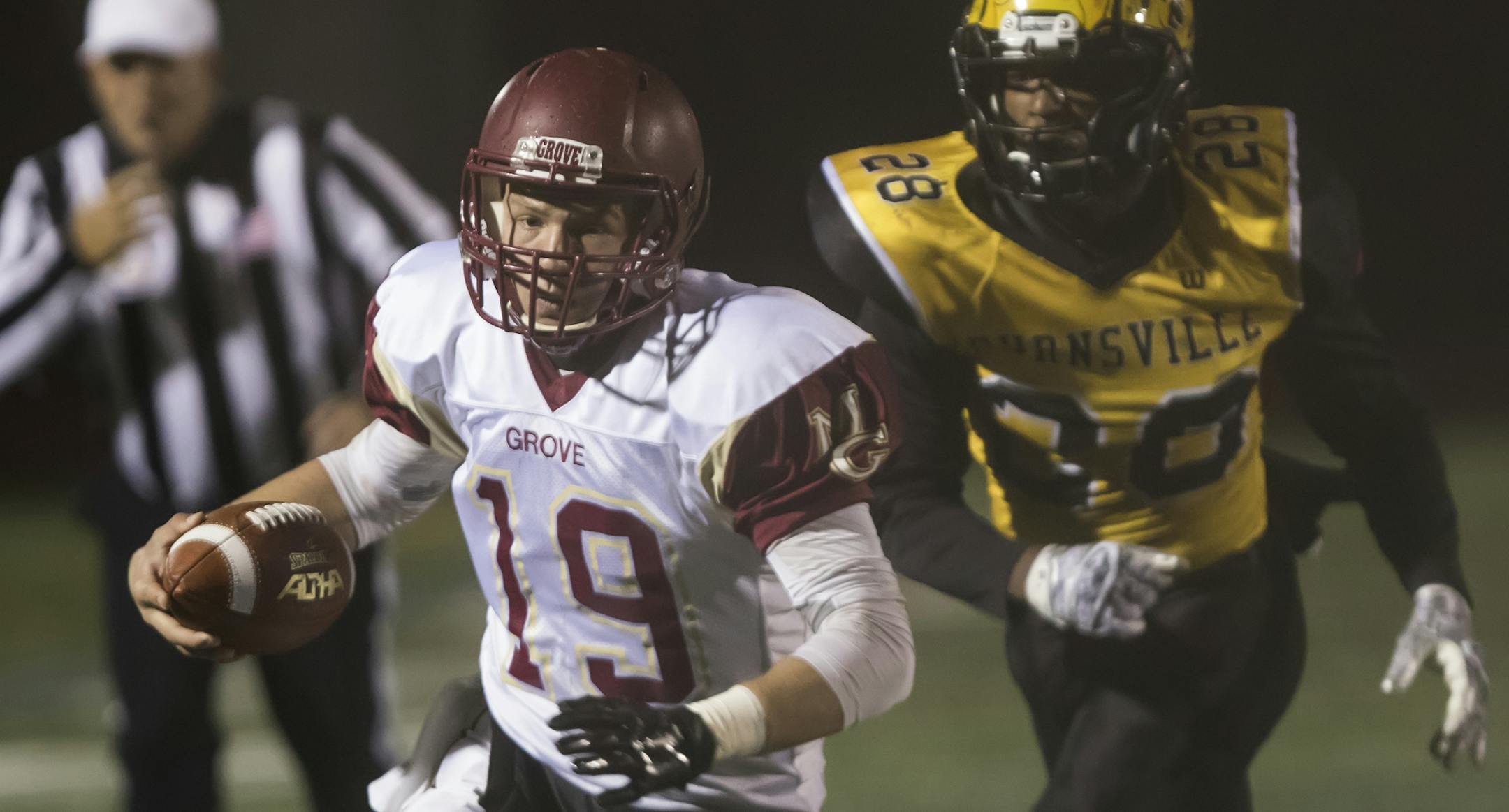 Maple Grove quarterback Brad Davison (19) runs the ball into the end zone just out of reach for Burnsville line backer Steph Olson, Jr. (28) as the Burnsville Blaze faced the Maple Grove Crimson in MSHSL Football playoffs at Hopkins High School on October 30, 2015. ] MATT BLEWETT ï matt@mattebphoto.com - October 30, 2015, Hopkins, MN, Burnsville High School, Maple Grove Crimson, Prep Football, Burnsville Blaze vs. Maple Grove Crimson
