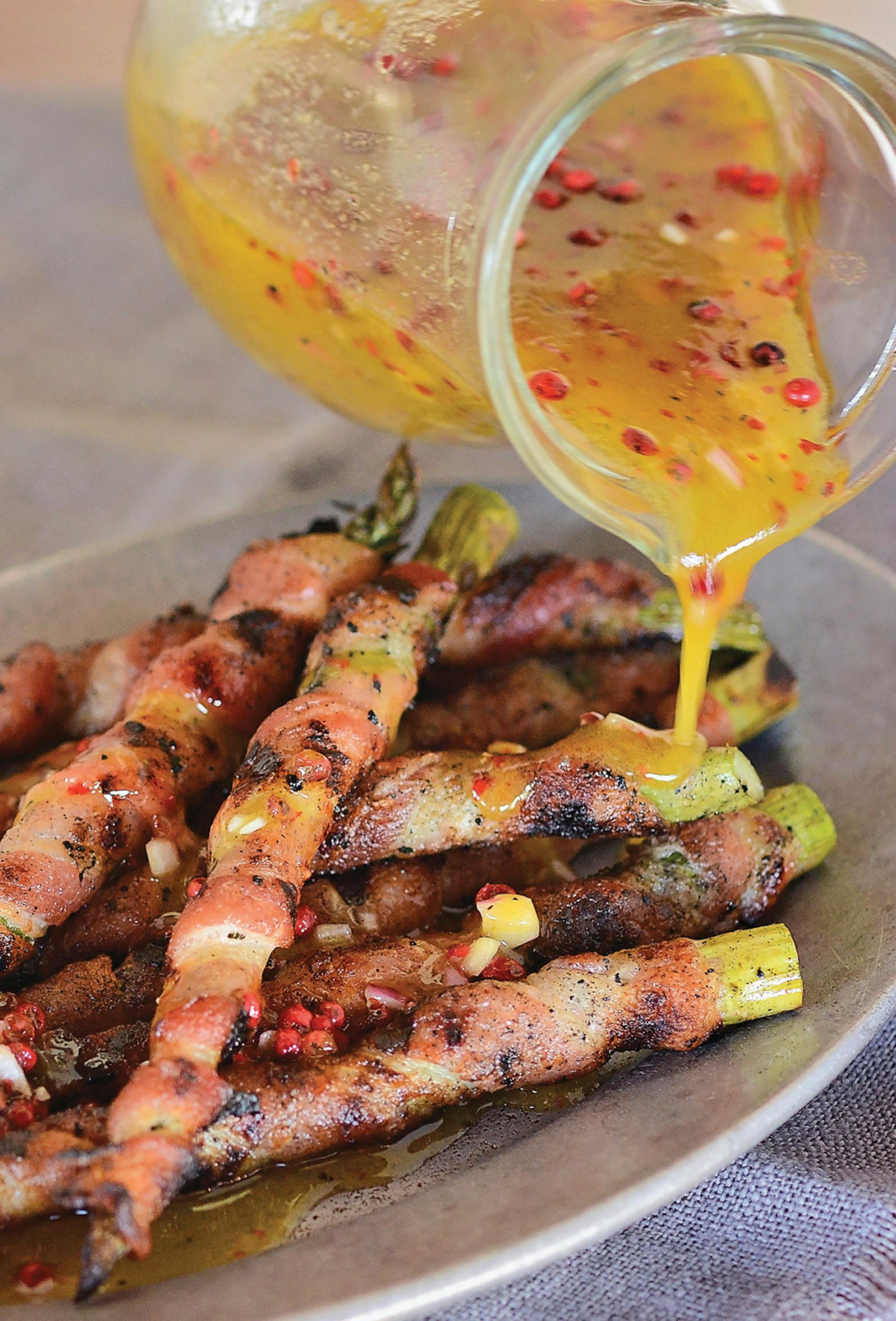 Bacon-Wrapped Asparagus With Pink Peppercorn Vinaigrette from ìSmokiní Hot in the South,î by Melissa Cookston.
