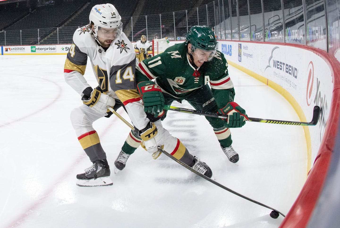 Nicolas Hague (14) of the Las Vegas Golden Knights and Zach Parise (11) of the Minnesota Wild fought for the puck in the first period.