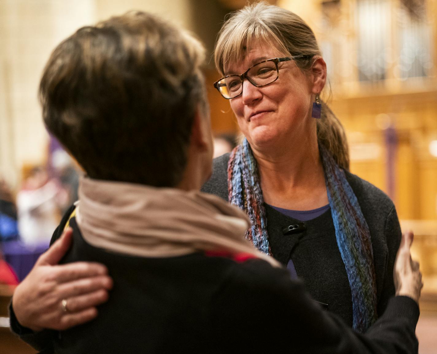 The Rev. Judy Zabel, right, hugged Cheryl Hauser after Ash Wednesday services at Hennepin United Methodist Church. "It was heartbreaking," Zabel said of last month's vote.