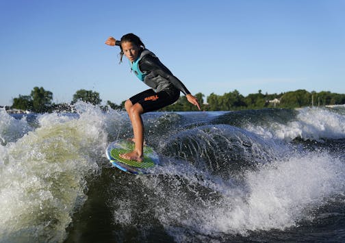 Bethany Anderson, 13, wake boards Friday on Lake Minnetonka in Orono, MN. The Anderson family is among a growing population that participate in the water sport but some home owners on the lake would restrict the use of wake boats that produce the waves for wake boarding.