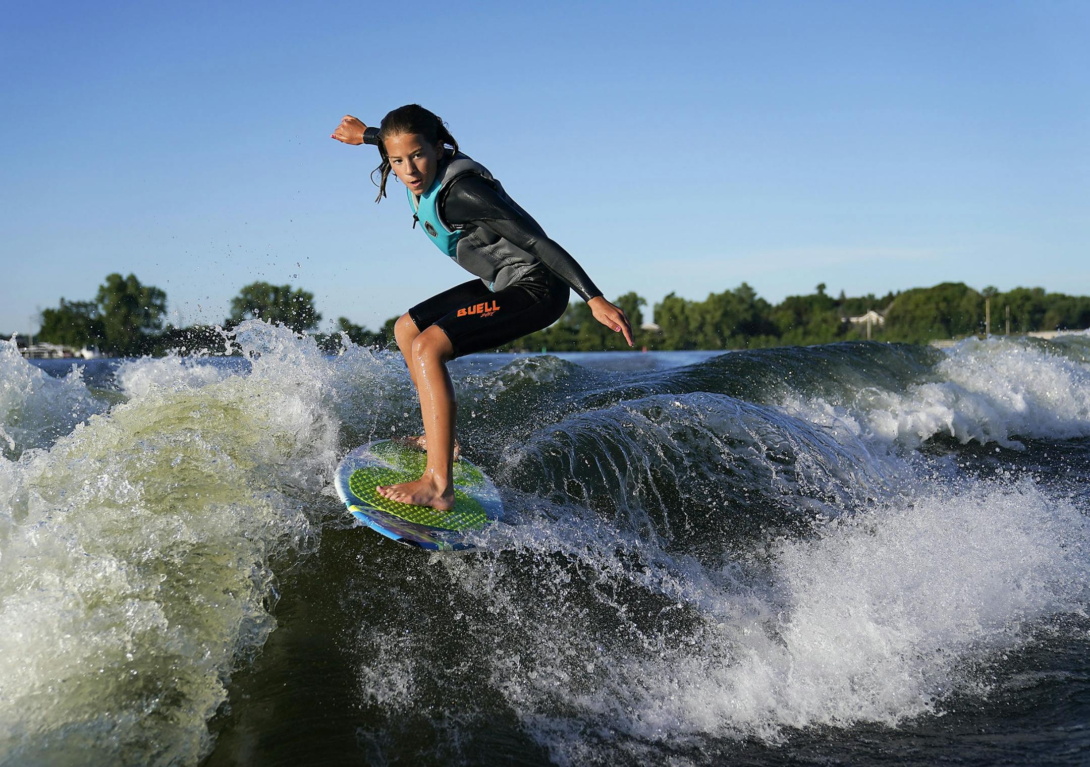 Bethany Anderson, 13, wake boards Friday on Lake Minnetonka in Orono, MN. The Anderson family is among a growing population that participate in the water sport but some home owners on the lake would restrict the use of wake boats that produce the waves for wake boarding.