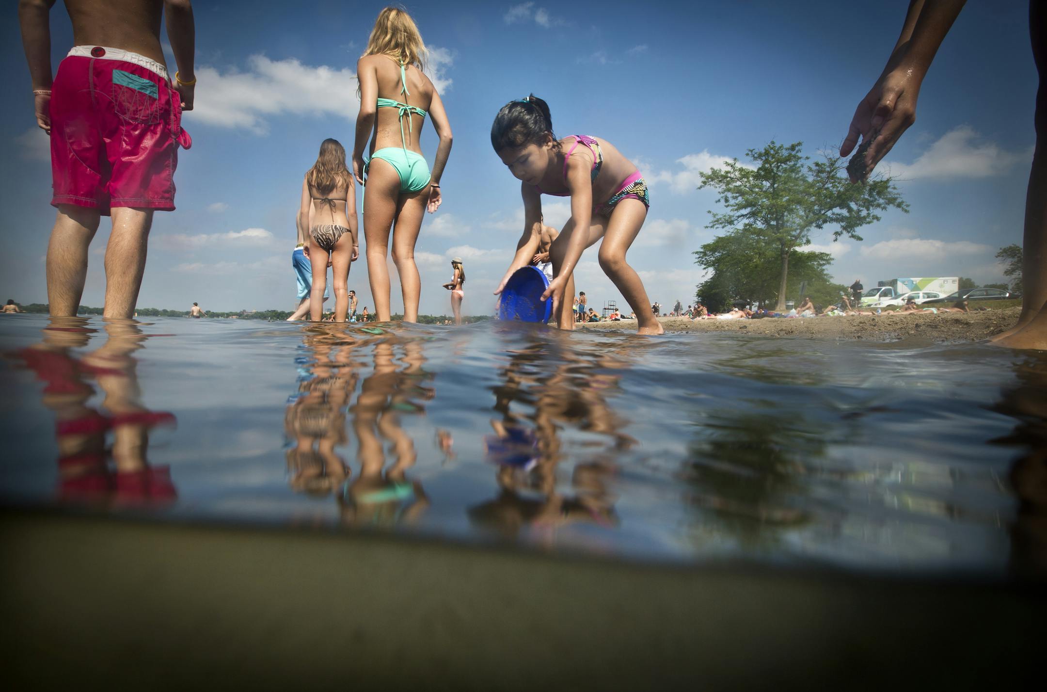 Jiselle Renville, 5, played in the water at Lake Calhoun&#x2019;s Thomas Beach on Tuesday. Milfoil topped out below the surface on Calhoun this year.