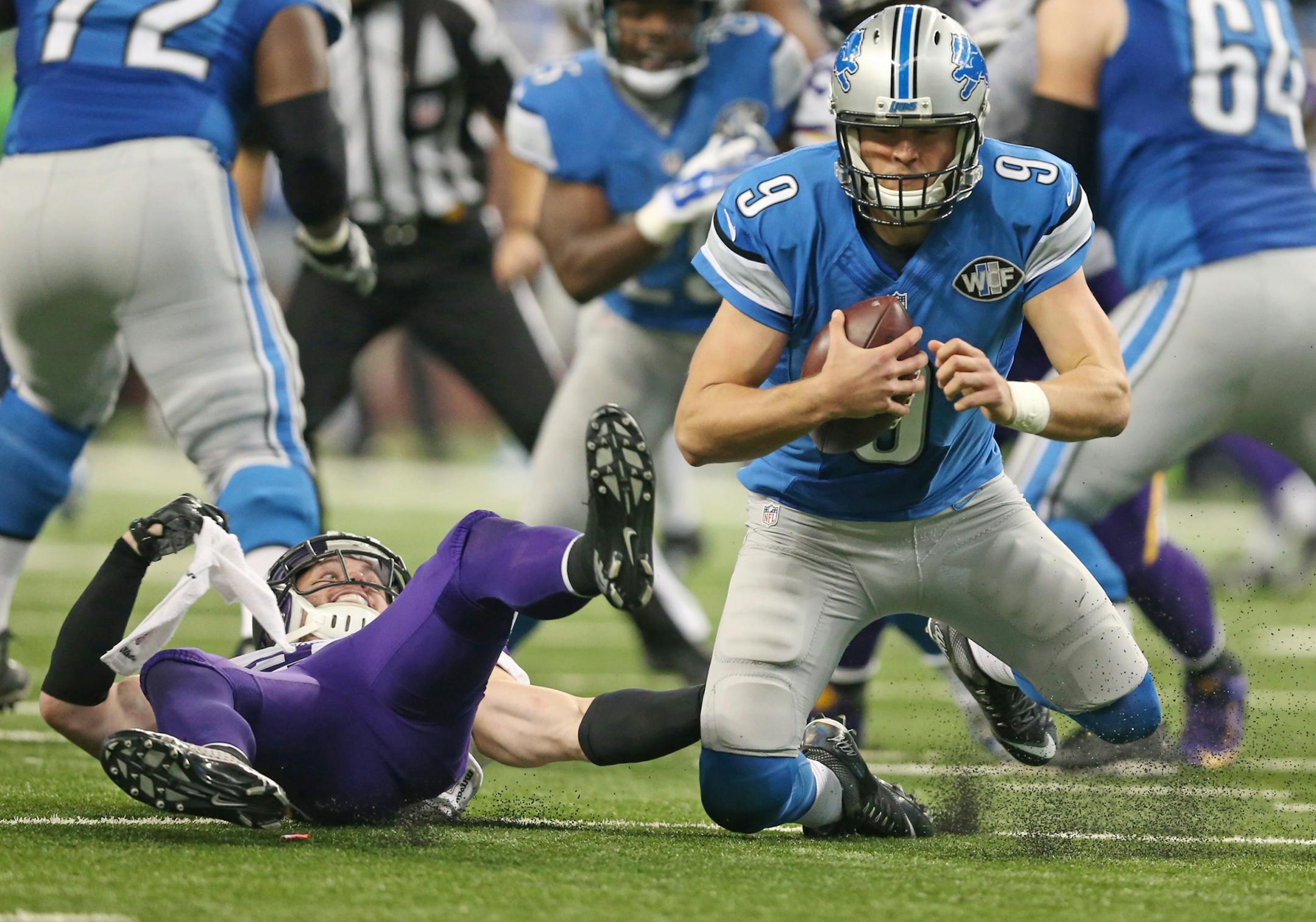 Detroit Lions quarterback Matthew Stafford (9) was sacked in the second quarter by Minnesota Vikings free safety Harrison Smith (22) at Ford Field Sunday October 25, 2015 in Detroit, MI.