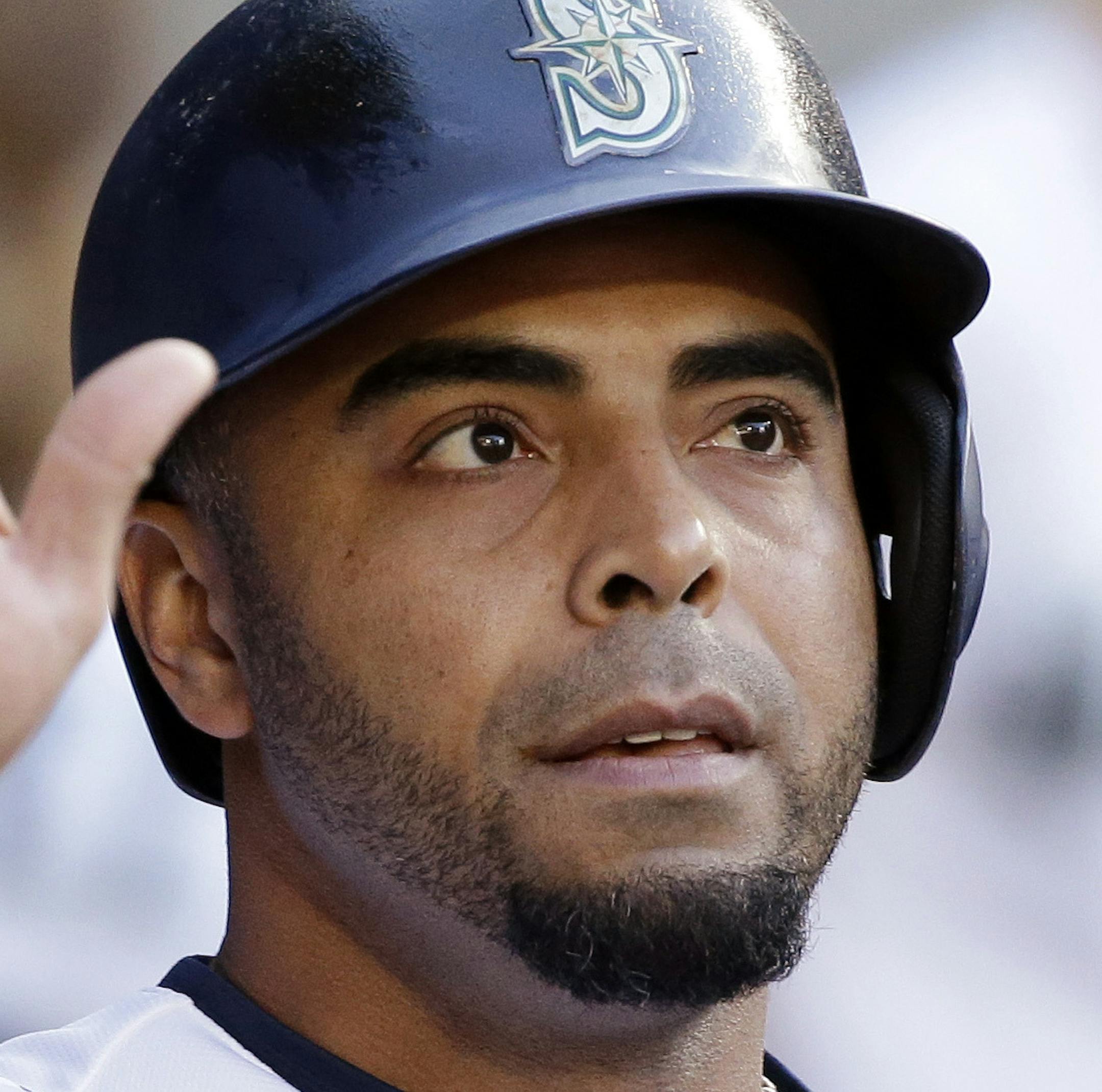 Seattle Mariners' Nelson Cruz is congratulated after scoring against the Tampa Bay Rays in the second inning of a baseball game Saturday, June 3, 2017, in Seattle. (AP Photo/Elaine Thompson)