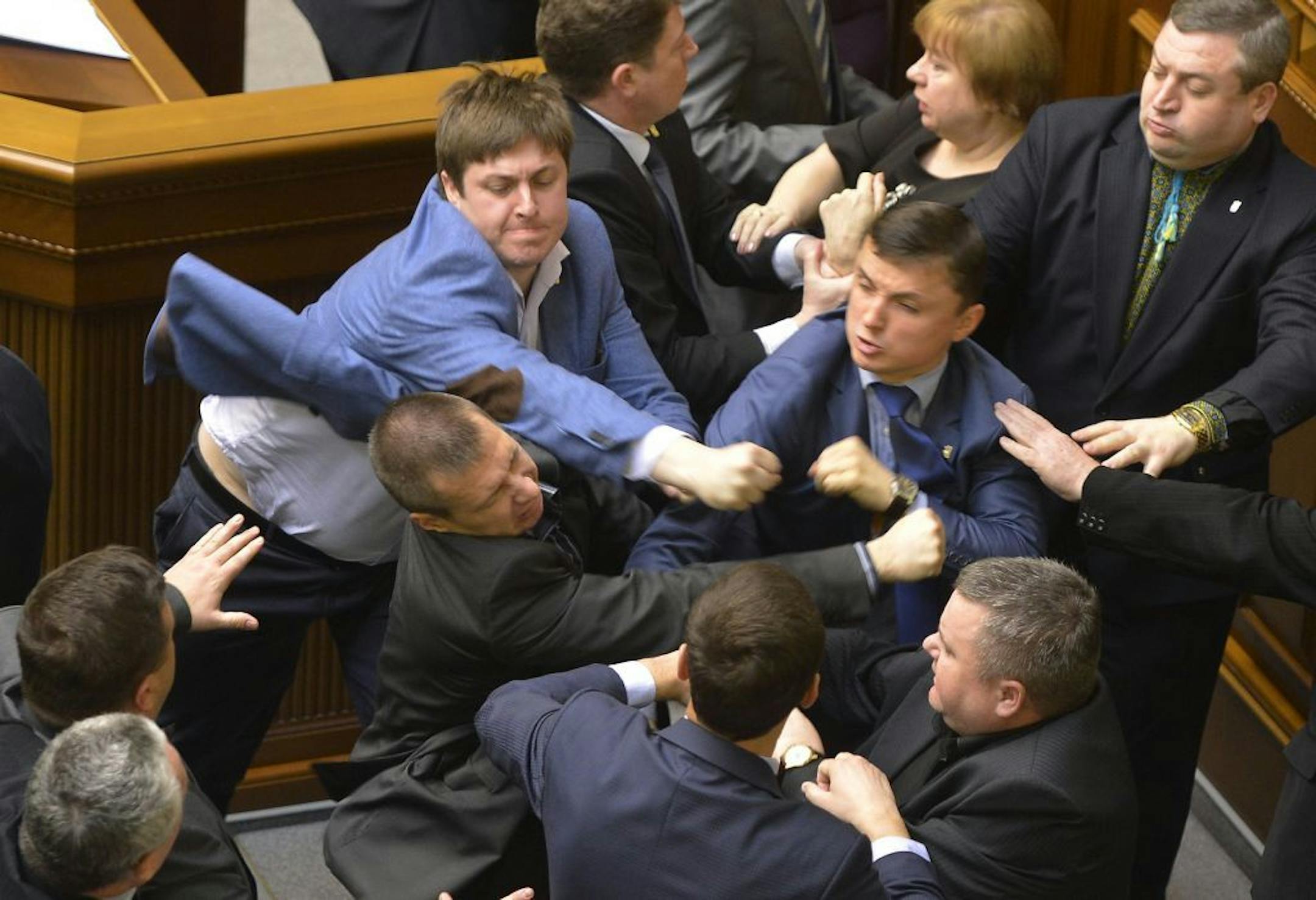 Communist lawmakers scuffle with right-wing Svoboda ( Freedom) Party lawmakers during a parliament session of Verkhovna Rada, the Ukrainian parliament, in Kiev, Ukraine Tuesday, April 8, 2014.