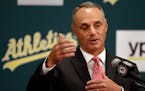 Baseball Commissioner Rob Manfred gestures during a media conference Friday, June 19, 2015, prior to a baseball game between the Los Angeles Angels an