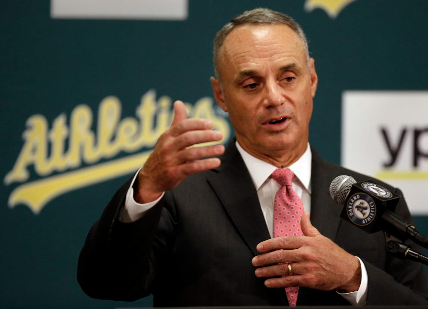 Baseball Commissioner Rob Manfred gestures during a media conference Friday, June 19, 2015, prior to a baseball game between the Los Angeles Angels and the Oakland Athletics in Oakland, Calif. (AP Photo/Ben Margot)